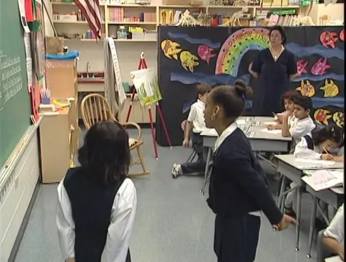 Students reading letters on board