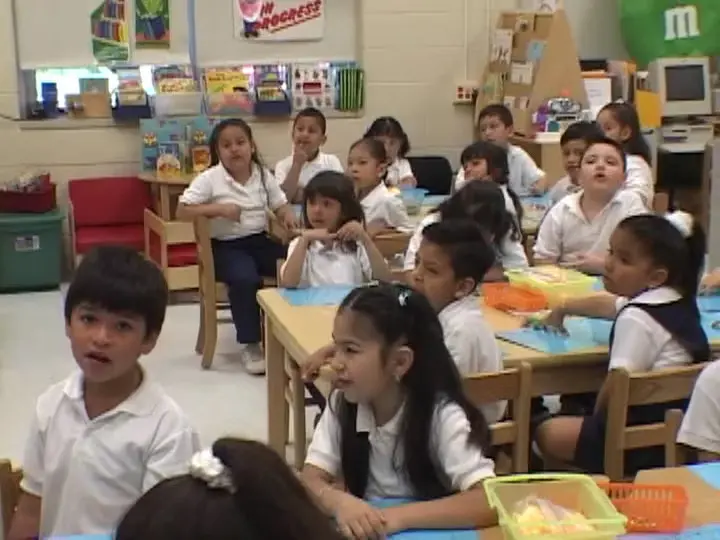 Children's are in school uniform sitting in classroom